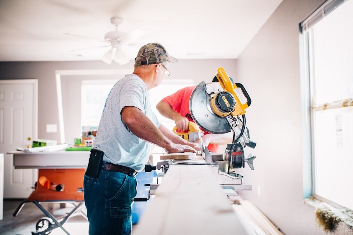 Free home repairs for senior citizens - handyman working with a miter saw on a home repair project